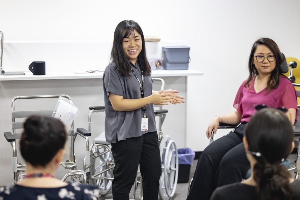 A Unicare Health clinical trainer educates occupational therapists about JUVOcare shower commodes
