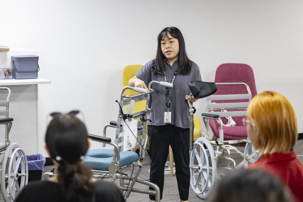 A Unicare Health clinical trainer demonstrates JUVOCare shower commodes at the Unicare Health free masterclass for occupational therapists