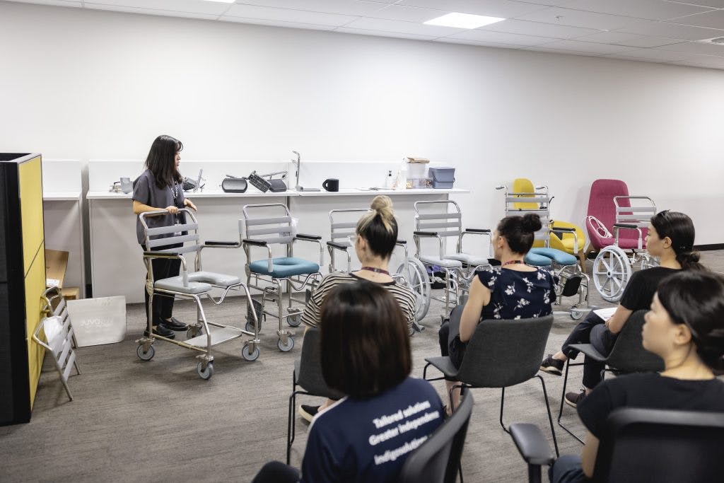 A Unicare Health clinical trainer demonstrates a range of JUVOCare shower commodes at the Unicare Health free masterclass for occupational therapists