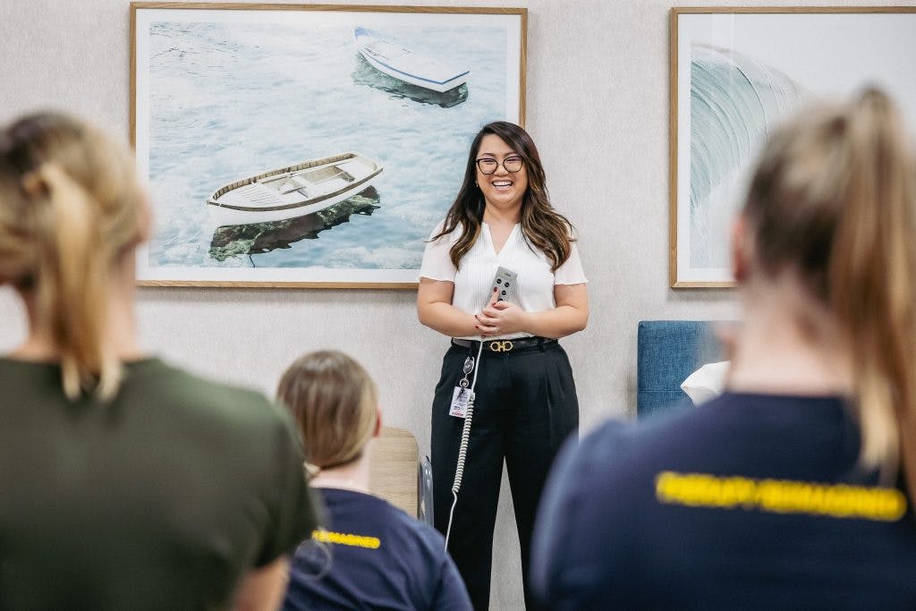 Unicare Health clinical educator Ilissa Liew engages SuperYou student therapists in discussion about electric profiling nursing care beds and pressure care mattresses