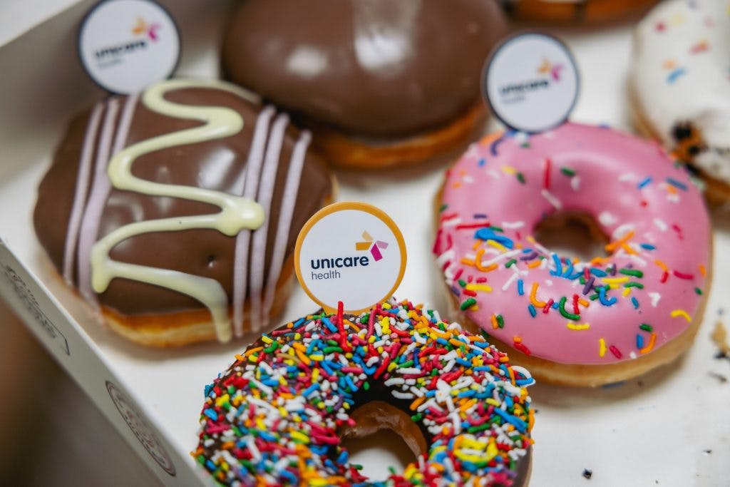 Krispy Kreme doughnuts decorated with Unicare Health logos