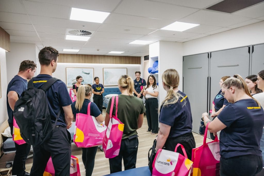 Superyou Therapists listen to a clinical trainer from Unicare Health discuss nursing care beds and pressure care mattresses in Open Showroom session