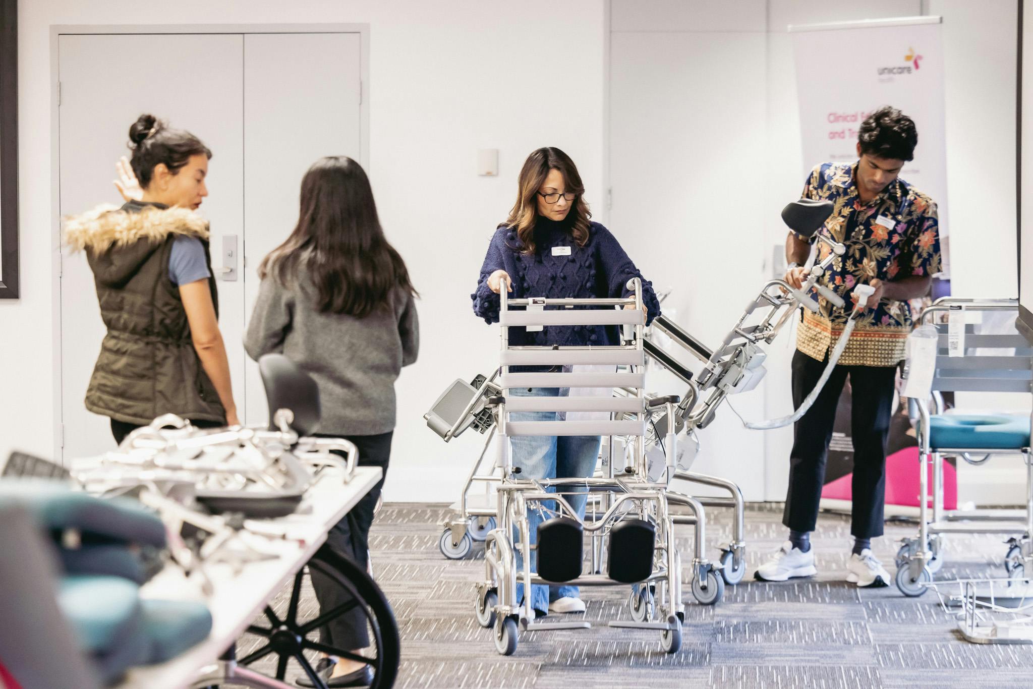 occupational therapists inspect JUVO shower commodes