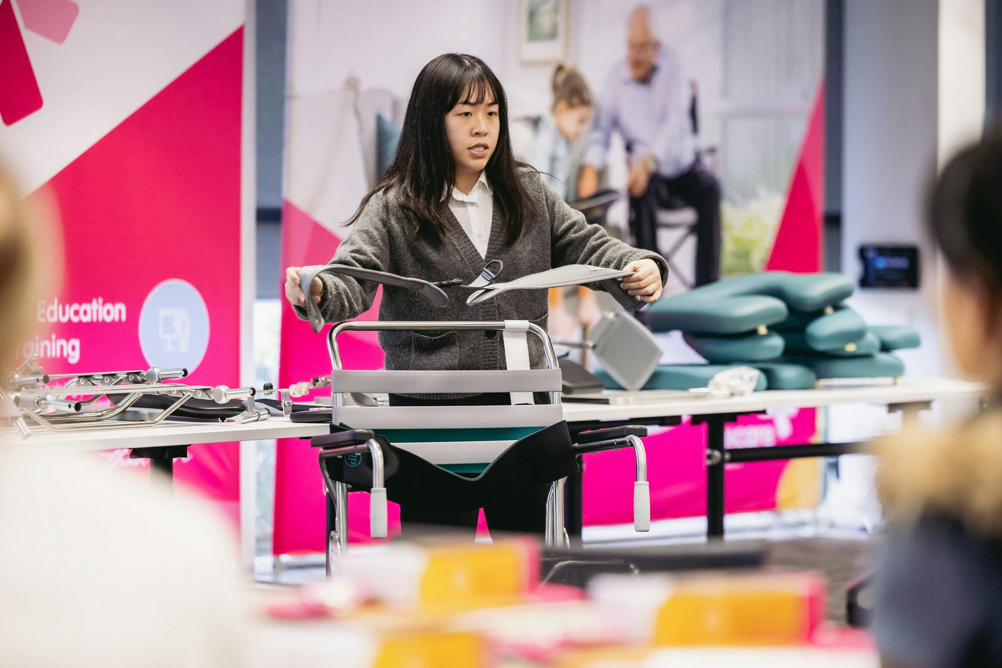 clinical educator showcases shower commode accessories to occupational therapists