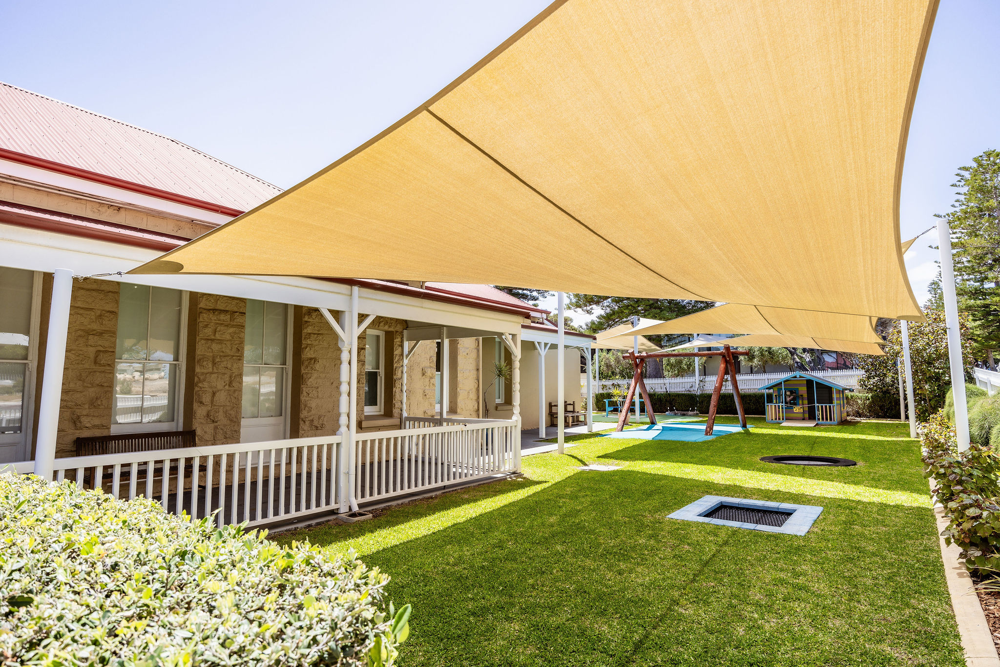 Accessible outdoor courtyard with shaded play area at Lady Lawley Cottage Cottesloe, Perth disability accommodation for children and families