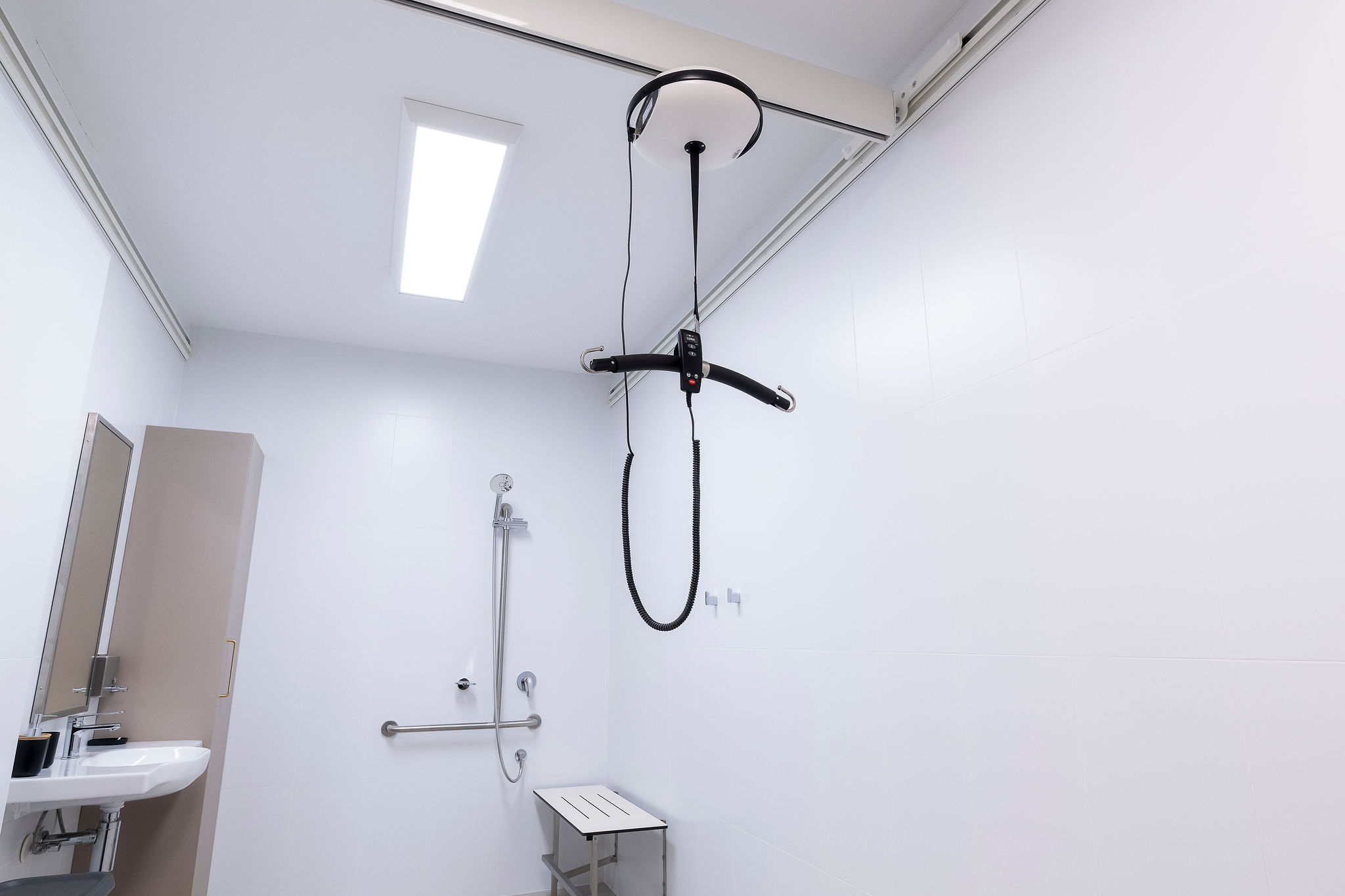 Accessible bathroom with ceiling hoist system and roll-in shower at Lady Lawley Cottage Cottesloe, Perth disability accommodation