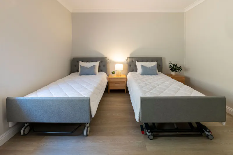 Twin accessible beds in disability-friendly bedroom at Lady Lawley Cottage Cottesloe, Perth short stay accommodation with mobility support features