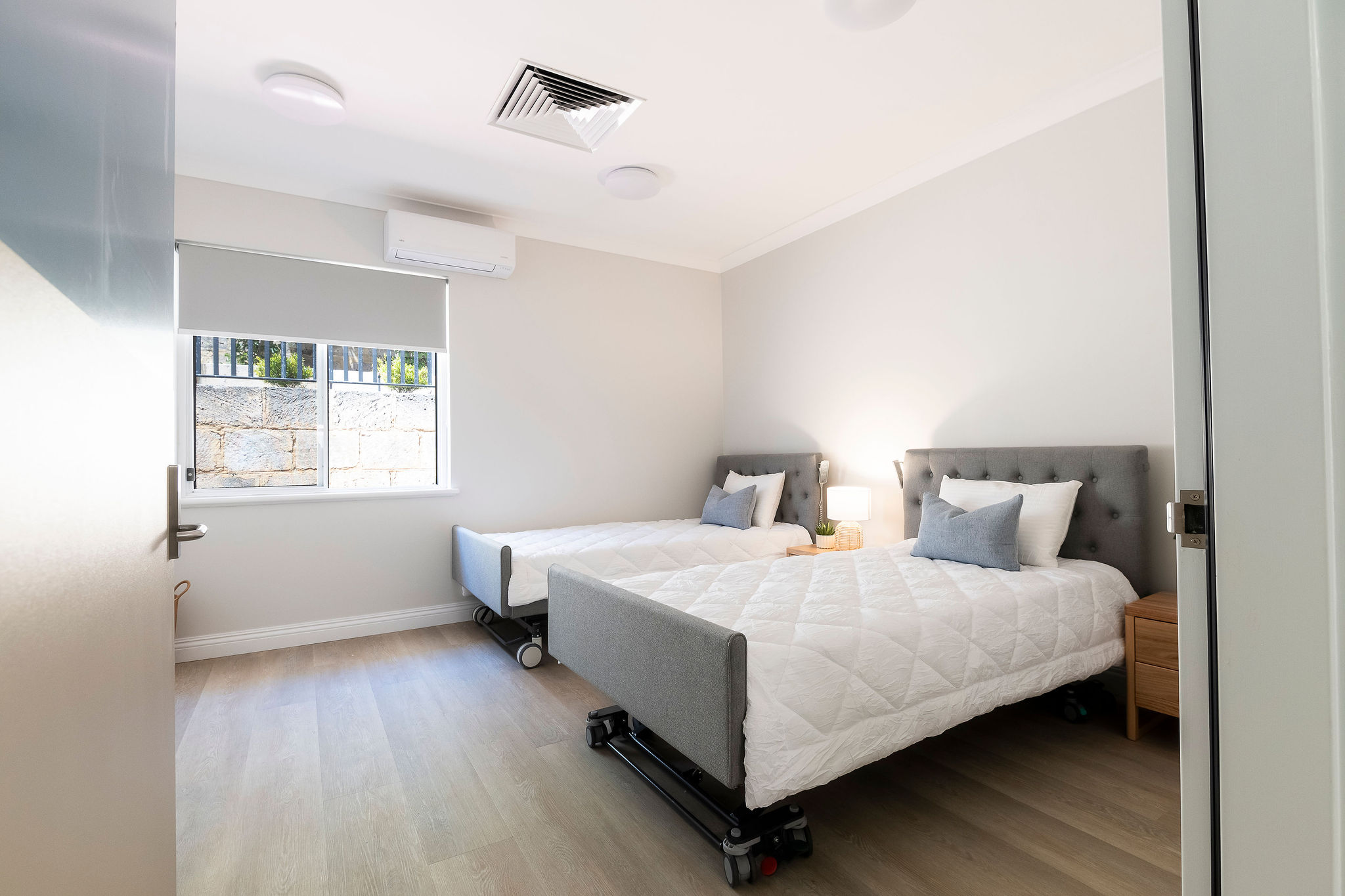 Accessible bedroom with adjustable beds at Lady Lawley Cottage in Cottesloe, Perth disability accommodation designed for comfort and mobility support