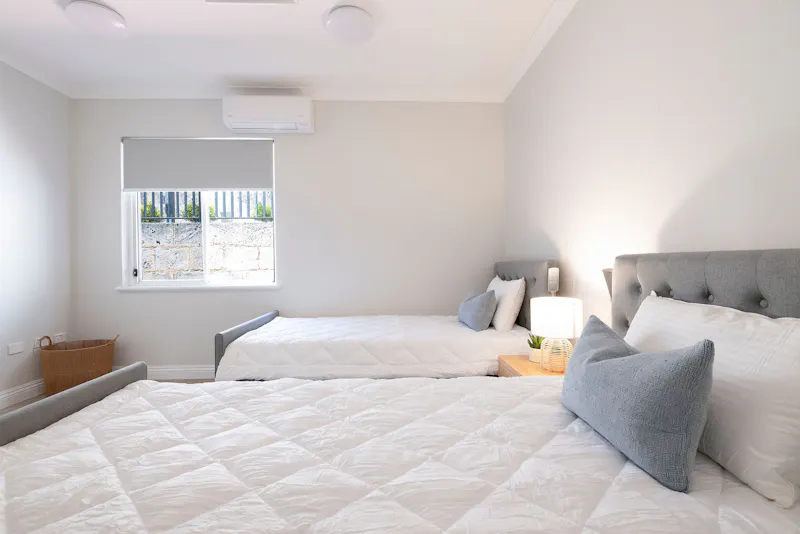 Accessible twin bedroom with mobility-friendly layout at Lady Lawley Cottage Cottesloe, Perth disability accommodation for short stays