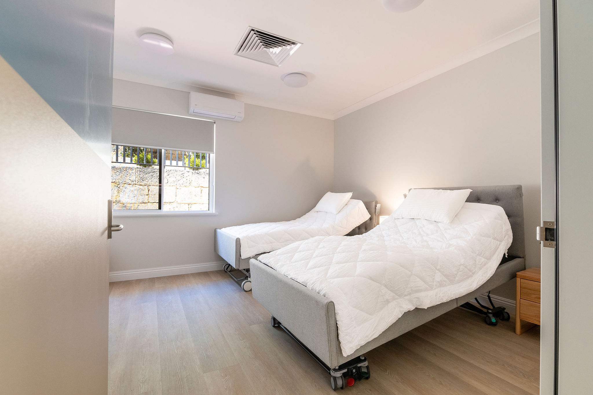 Accessible bedroom with electric adjustable beds at Lady Lawley Cottage Cottesloe, Perth disability accommodation for mobility support and comfort