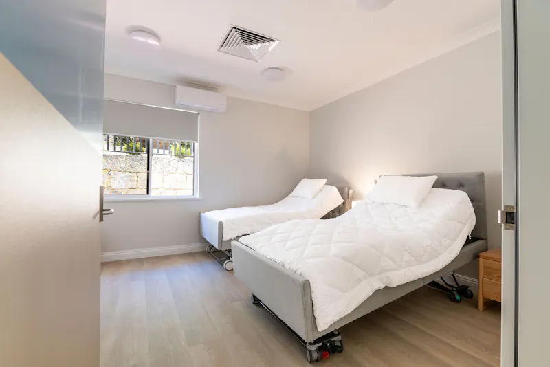 Accessible bedroom with electric adjustable beds at Lady Lawley Cottage Cottesloe, Perth disability accommodation for mobility support and comfort