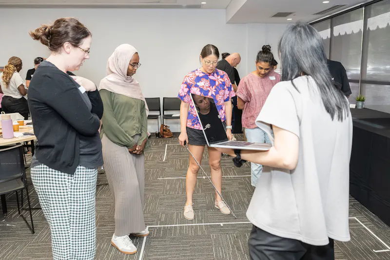 Occupational Therapists measuring and planning accessible bathroom layout during practical home modifications training session in Perth WA