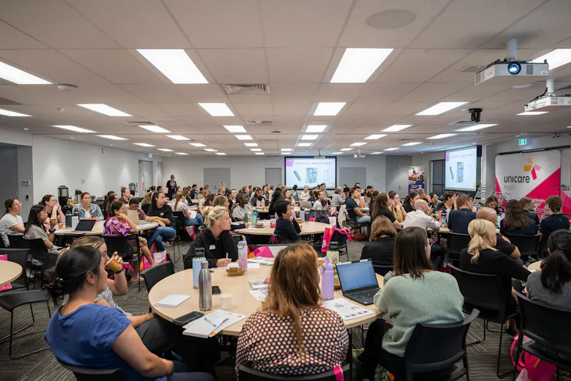 Healthcare professionals engaged in Unicare Health bathroom mobility and assistive technology training session in Bentley Perth WA, learning about shower commodes and home modifications