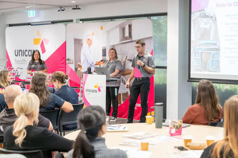 Unicare Health support team presenting on shower commode servicing, maintenance risks, and equipment support during bathroom mobility training in Perth WA