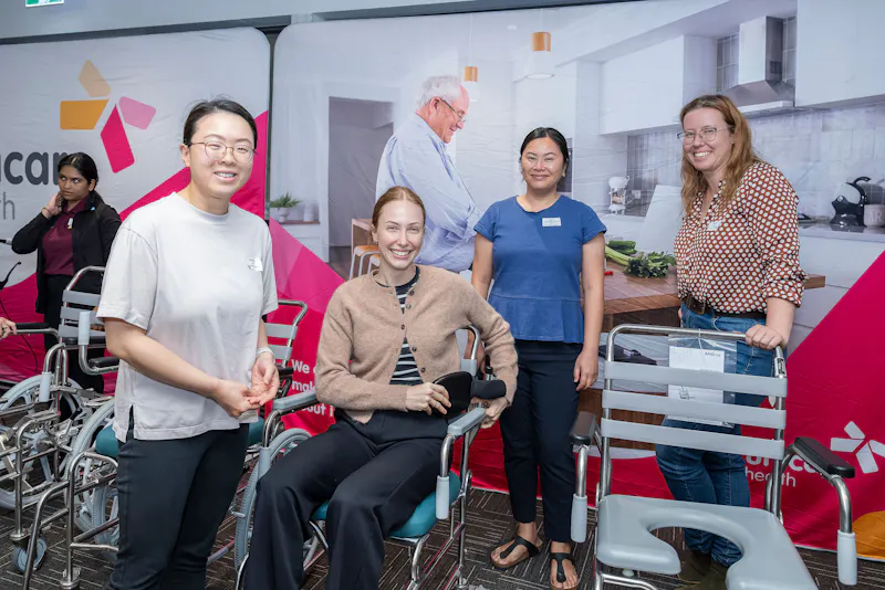 Occupational Therapists trialling shower commode equipment during Unicare Health bathroom mobility training workshop in Bentley Perth WA