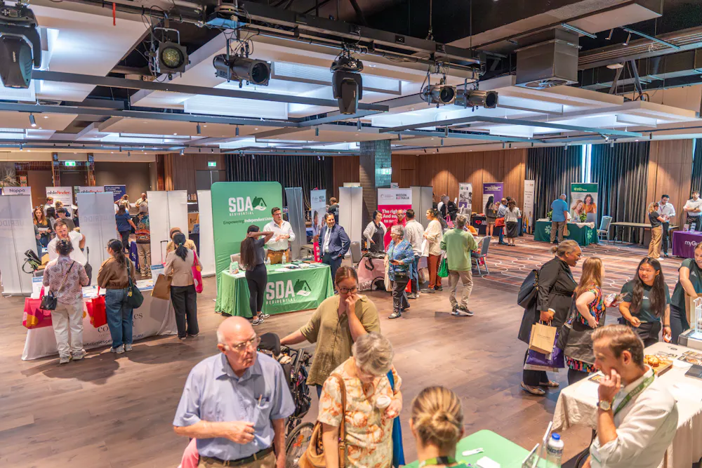 Busy exhibition floor at Bankstown Disability Expo NSW with attendees visiting provider stalls and connecting with local NDIS services at Canterbury League Club Belmore