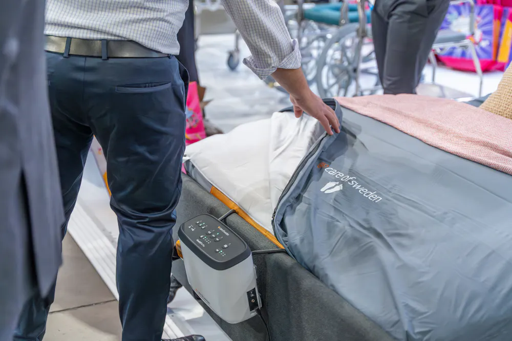 Pressure care mattress and electric profiling bed displayed at the Unicare Health stand during the ATSA Independent Living Expo Sydney 2026.