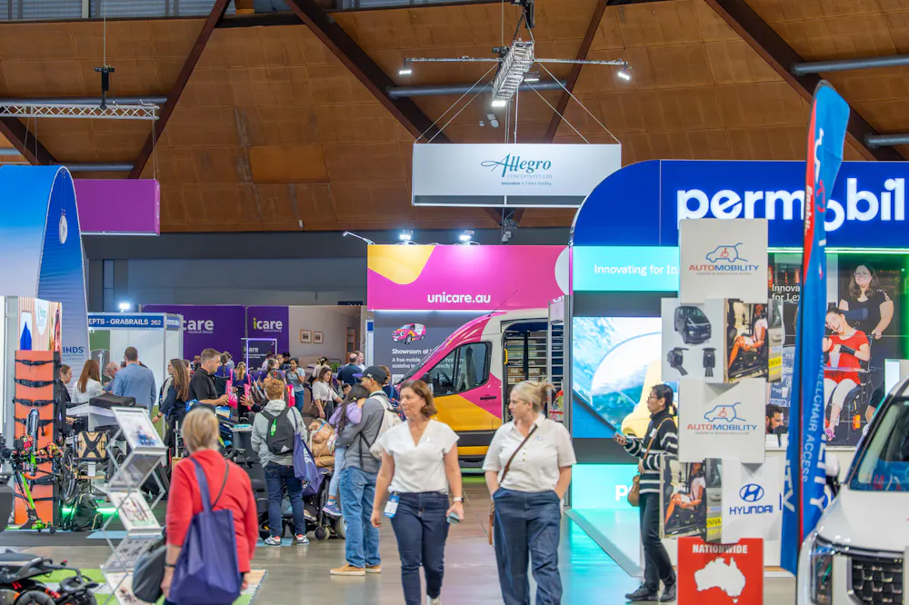 Crowds attending the ATSA Independent Living Expo Sydney 2026 with the Unicare Health stand and Showroom at Home™ van in the exhibition hall.