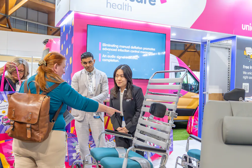 Unicare Health team discussing shower commode solutions with attendees at the ATSA Independent Living Expo Sydney 2026.