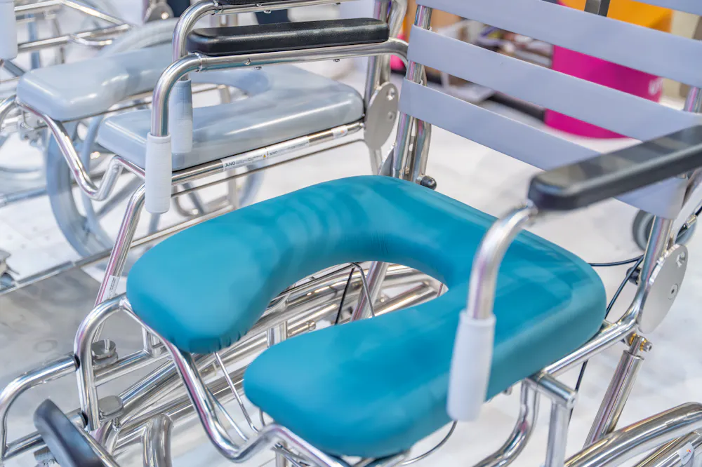 Close-up of a shower commode chair displayed at the Unicare Health stand during the ATSA Independent Living Expo Sydney 2026.