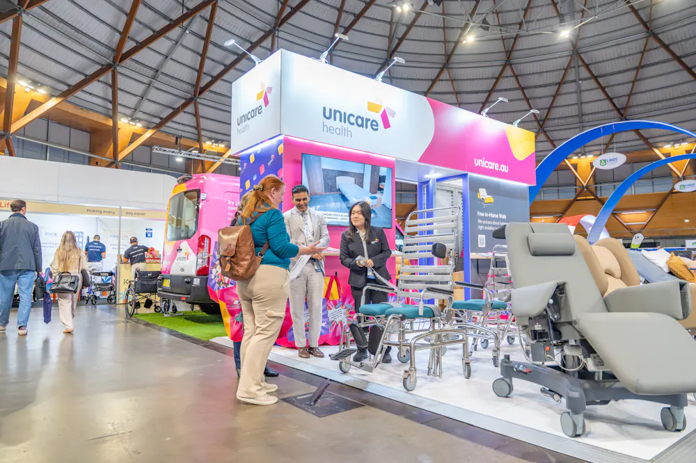 Unicare Health stand at the ATSA Independent Living Expo Sydney 2026 featuring shower commodes, procedure chairs and assistive technology equipment.