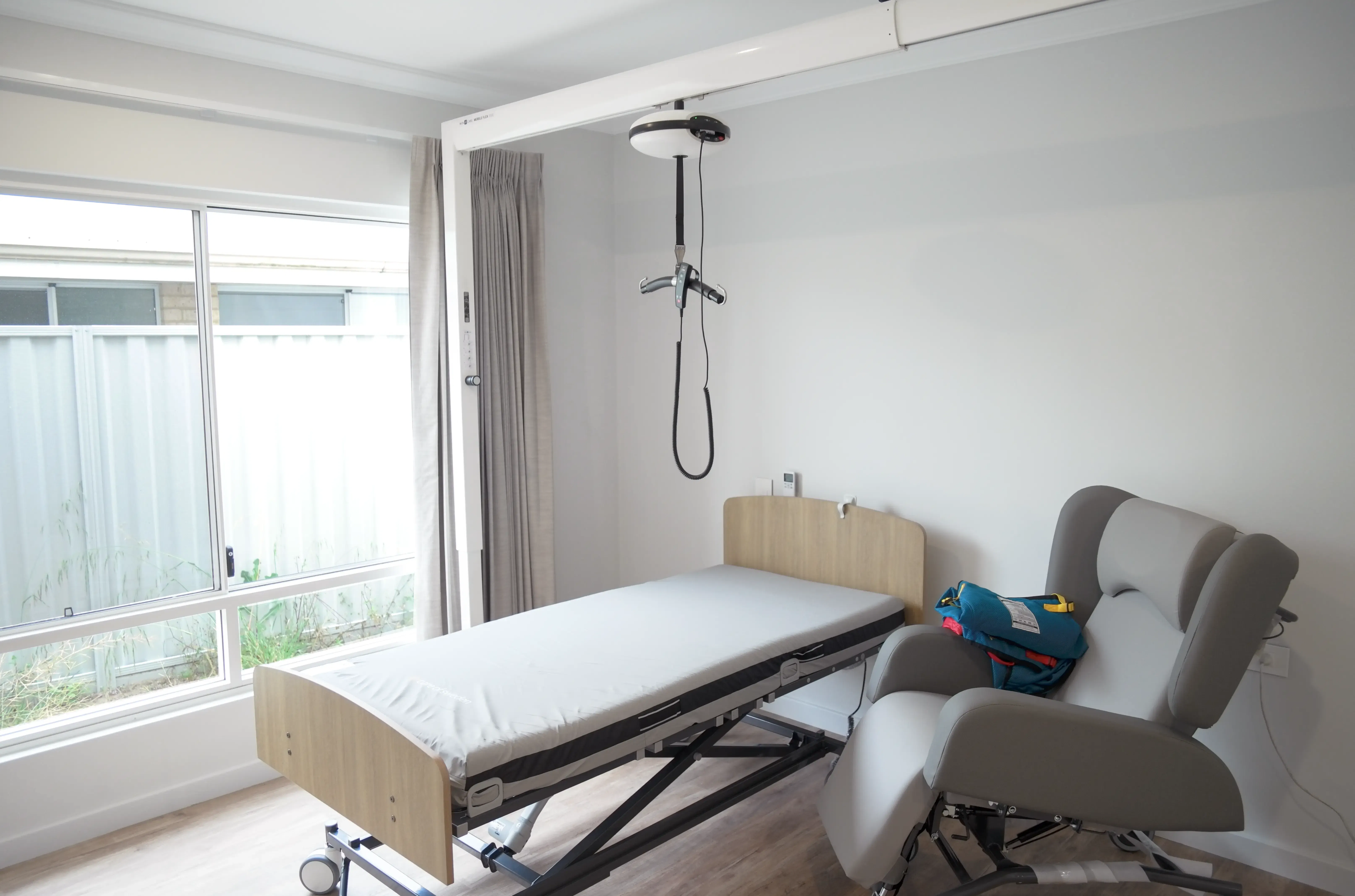 Ceiling hoist, adjustable care bed and supportive seating displayed inside the Sana Living demonstration home in Atwell.