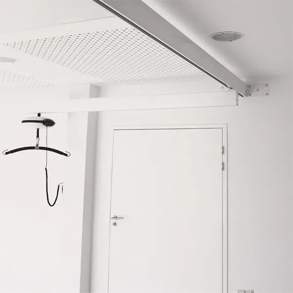 Ceiling hoist track secured with brackets above a doorway.