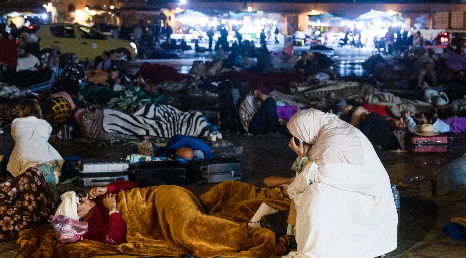 Residents stay out at a square in Marrakesh on September 9, 2023, after a powerful earthquake rocked the country. 