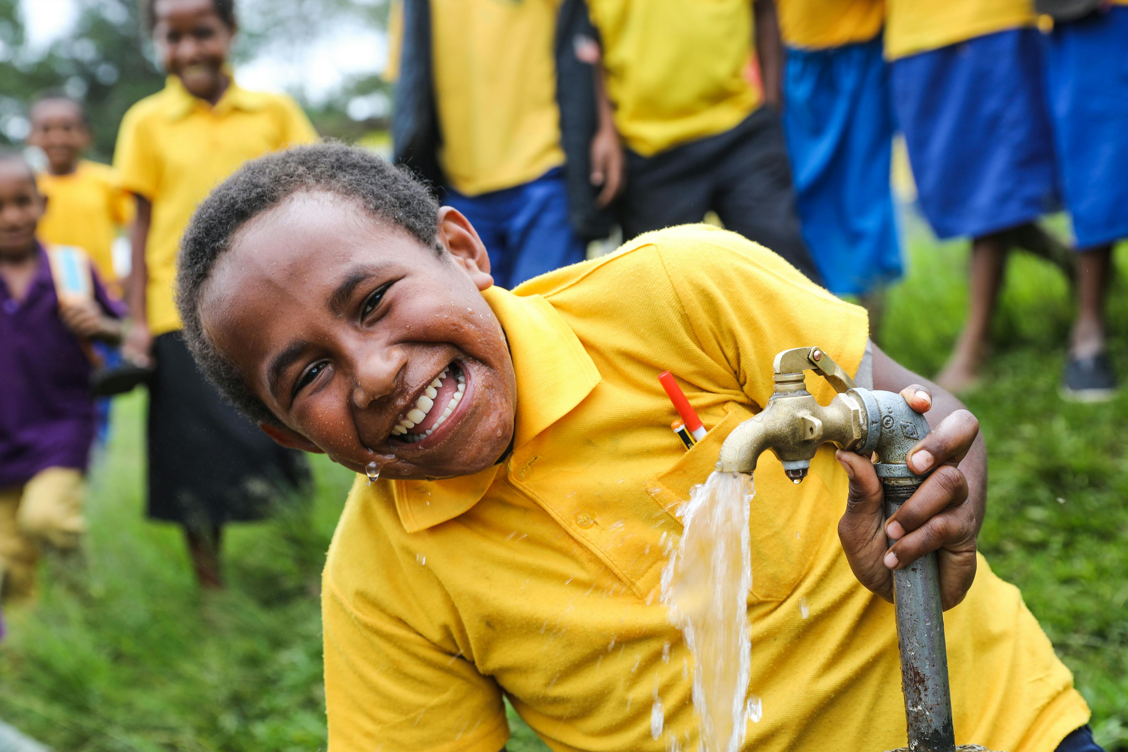 Ryan (11) is happy to have clean, safe drinking water at his school in Mendi, Papua New Guinea.