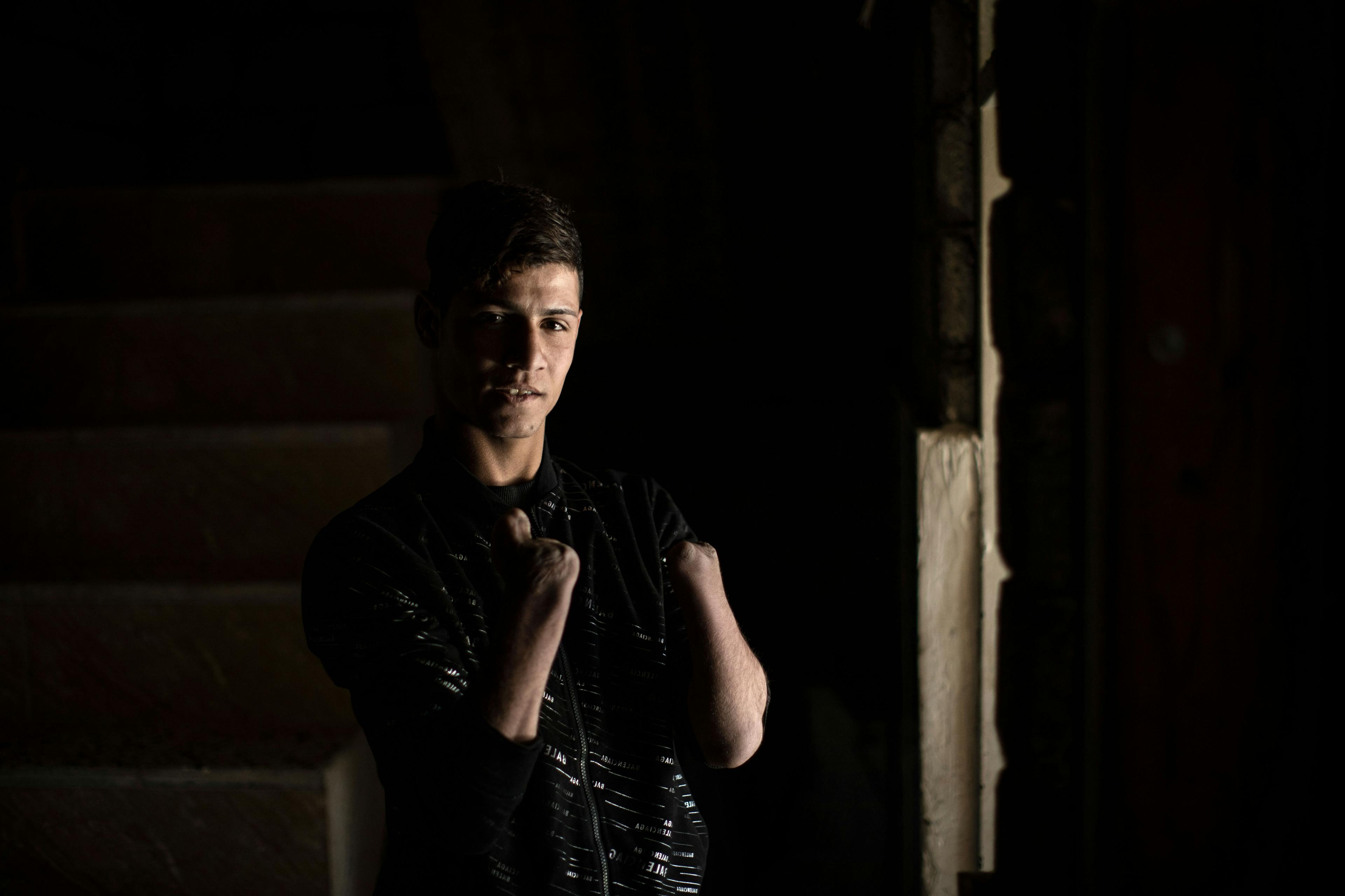 On 7 March 2022 in Iraq, a portrait of 17-year-old Ali, made inside his home in Mesherfa, on the outskirts of Mosul. Ali lost both hands hands during a shelling in West Mosul in 2017, trapped in the midst of combat between ISIS and liberating forces.
