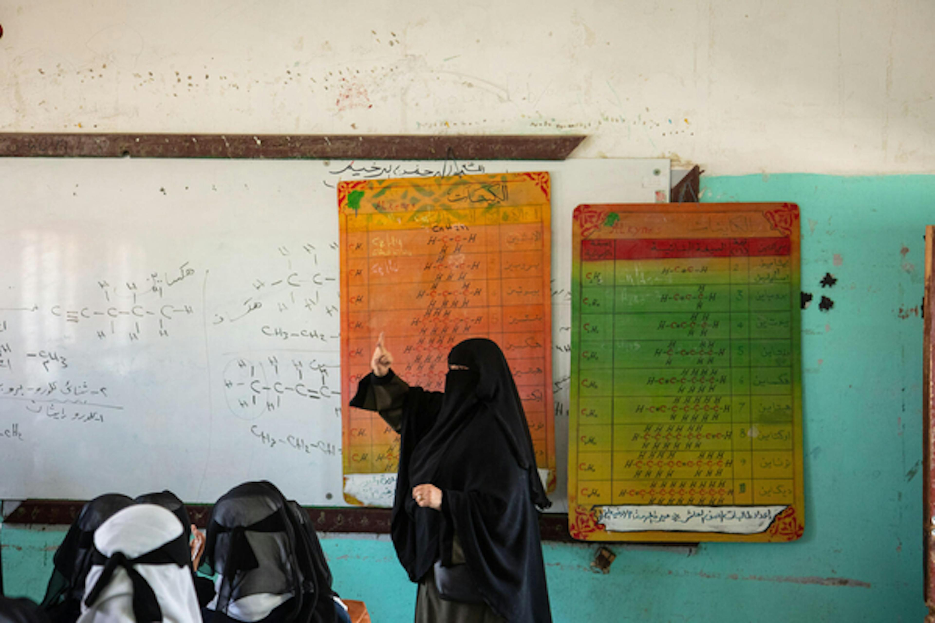 Eman Al-Muhanash, a chemistry teacher, teaches her class at Al-Zahra'a School in Dhamar Governorate, Yemen.