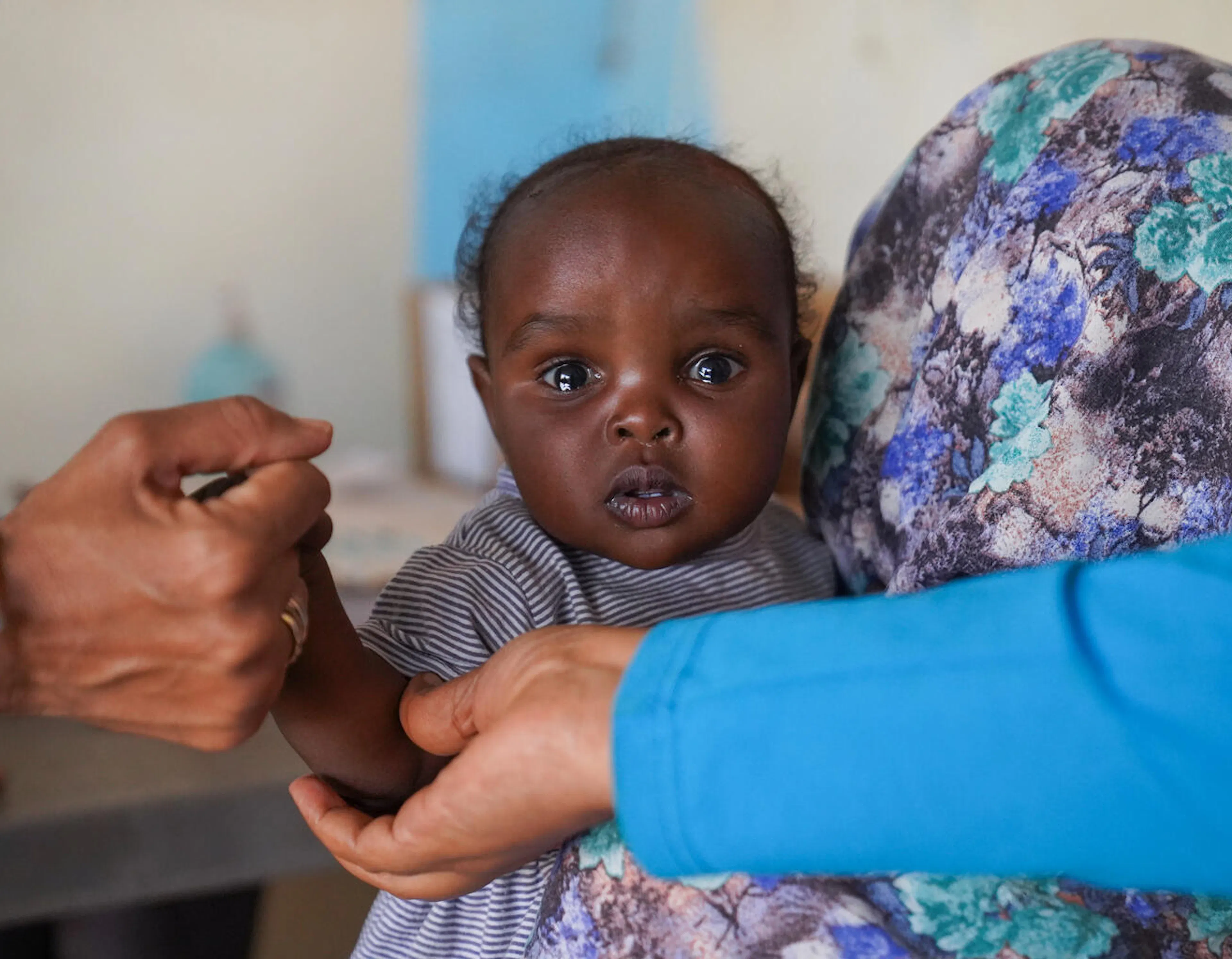 Madina brings her seven-month-old daughter, Elaf, for vaccination on the final day of the measles campaign at a UNICEF-supported health facility in Tawila, North Darfur, Sudan.