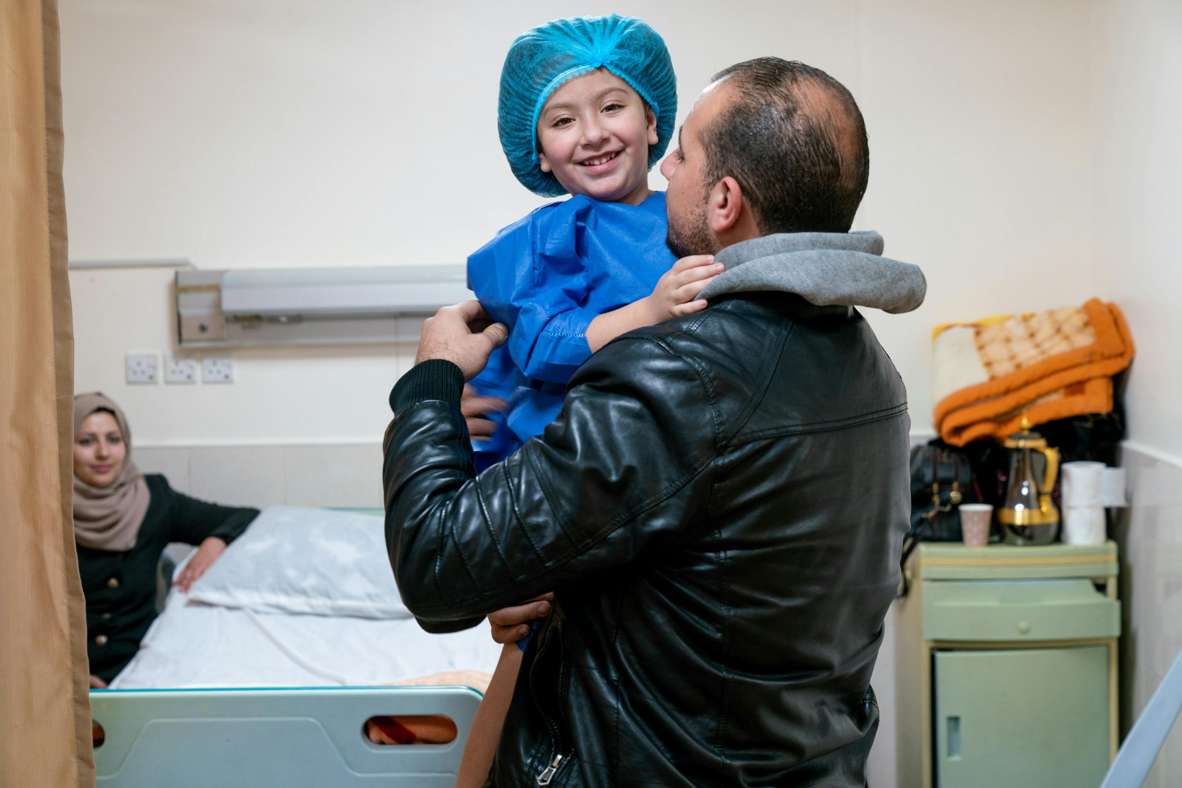 Health & Medicine- Julie, 4 years, with her father Ali. Julie, who is Jordanian, suffers from spina bifida and tibial derotation.