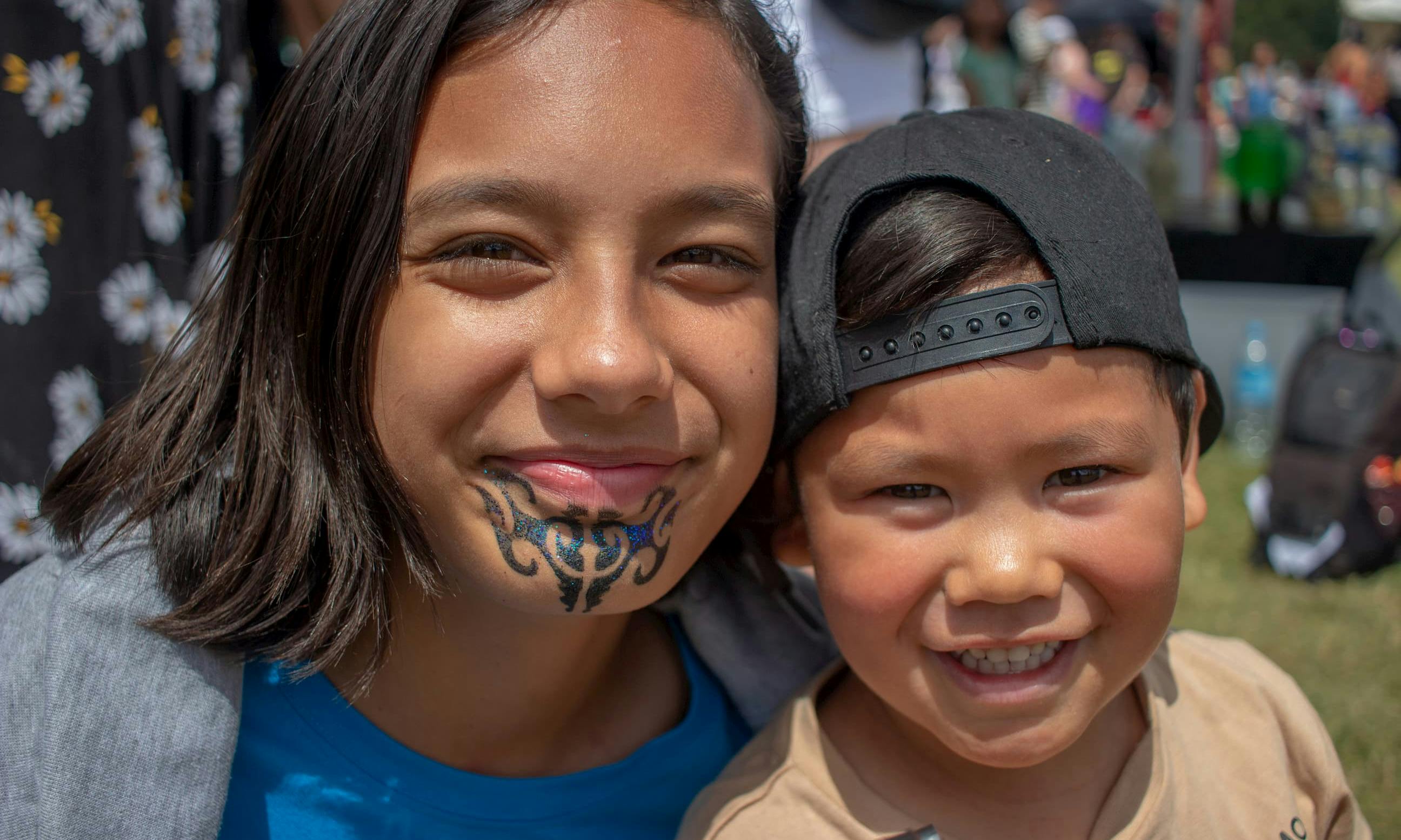Two Māori tamariki smiling at the camera during UNICEF children's day