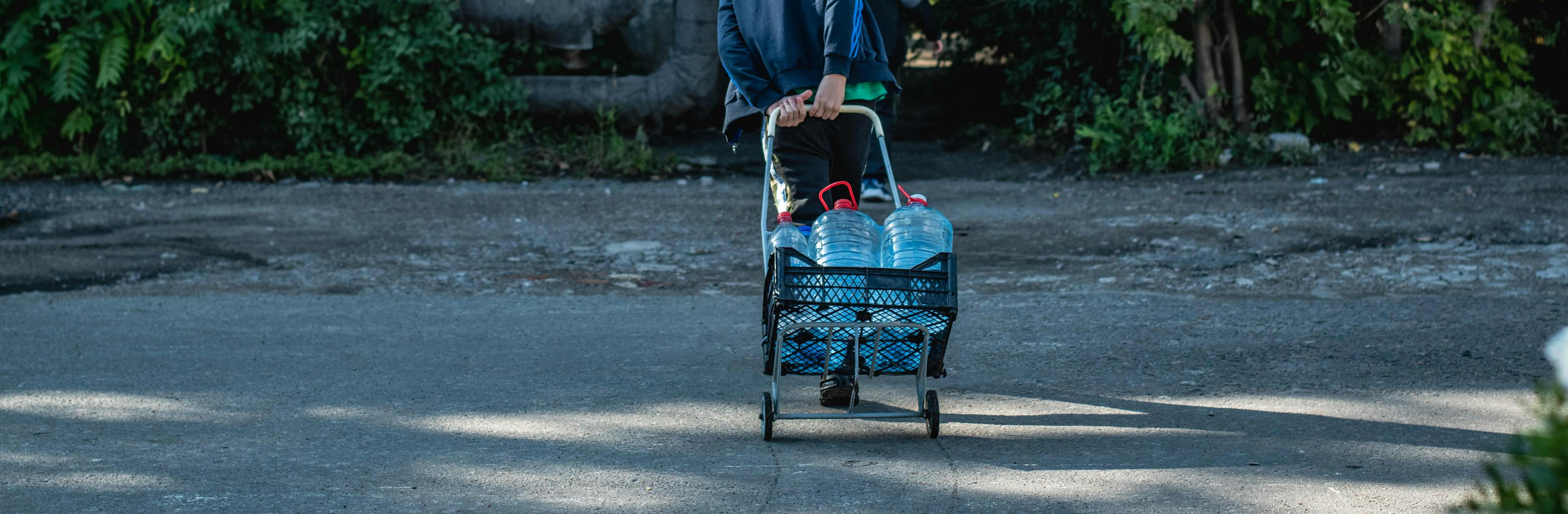 Boy carries bottles of water. Millions who live in the city of Mykolaiv, Ukraine, now have access to clean drinking water, thanks to UNICEF and partners.