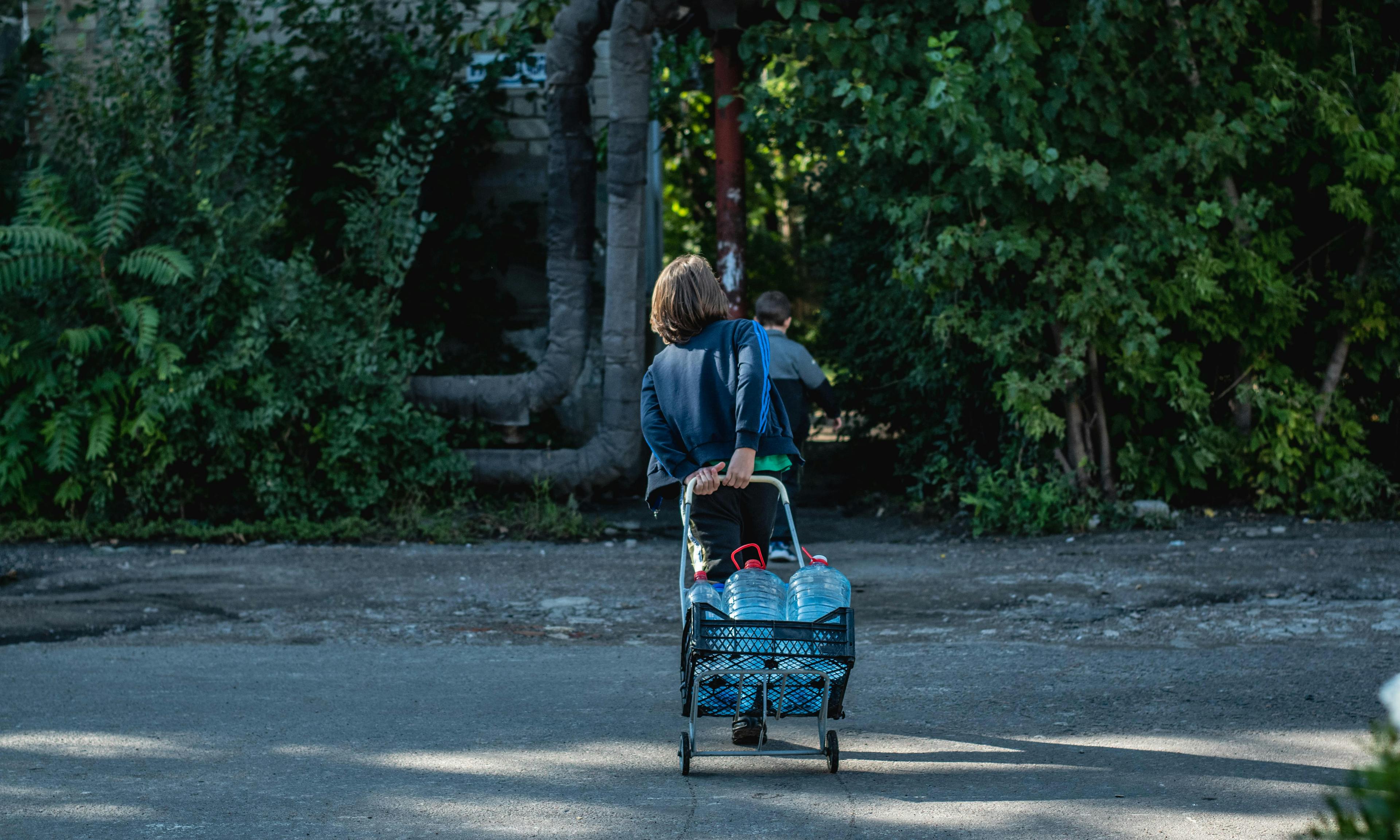 Boy carries bottles of water. Millions who live in the city of Mykolaiv, Ukraine, now have access to clean drinking water, thanks to UNICEF and partners.