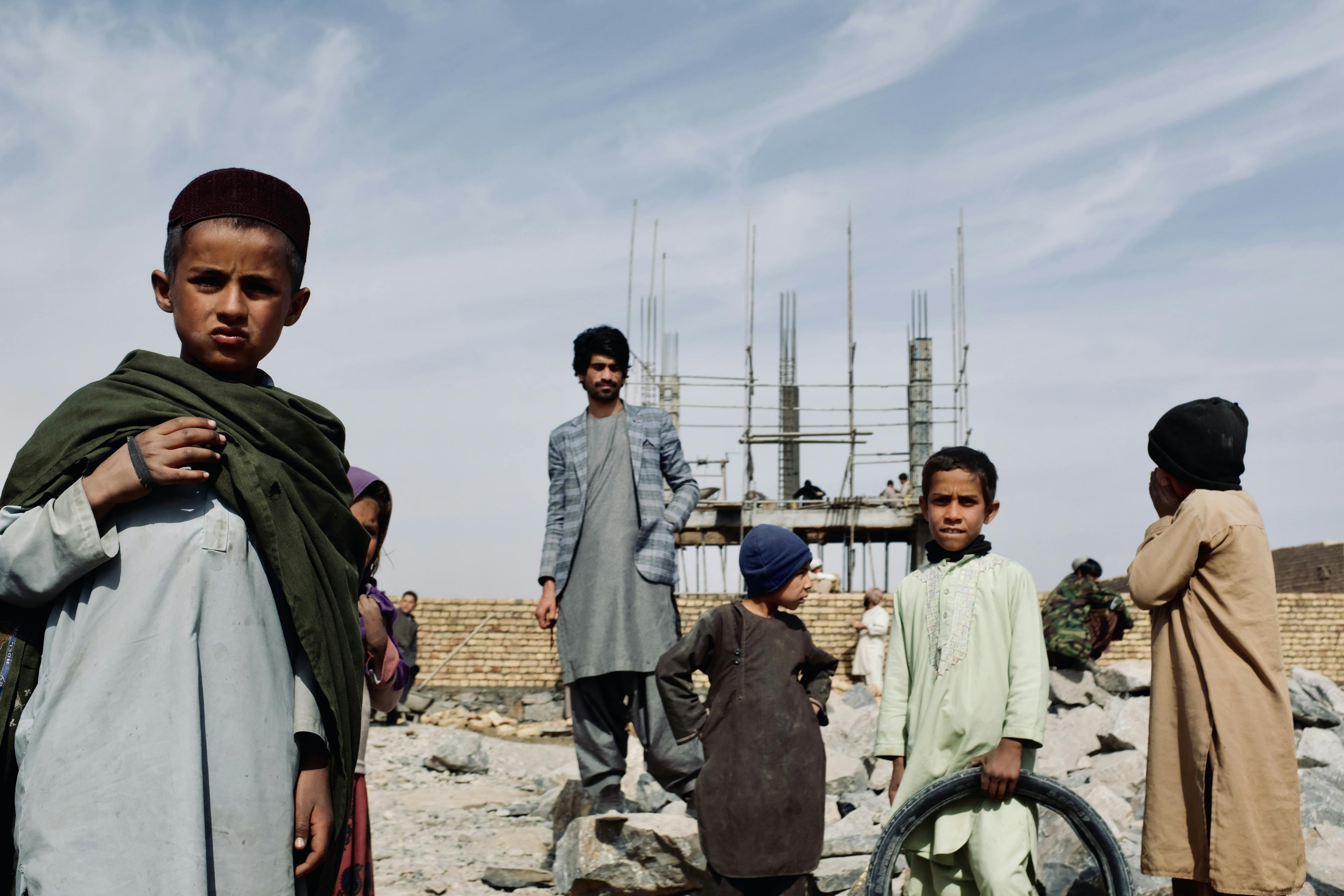 Children in front of the construction site of the new solar powered water house in Dand District, outside of Kandahar. Upon completion the tower will benefit close to 1,000 individuals.