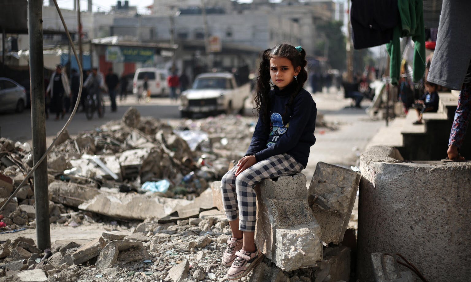 11 year-ol Maha sitting on the rubble of a house in Rafah, southern the Gaza Strip. 