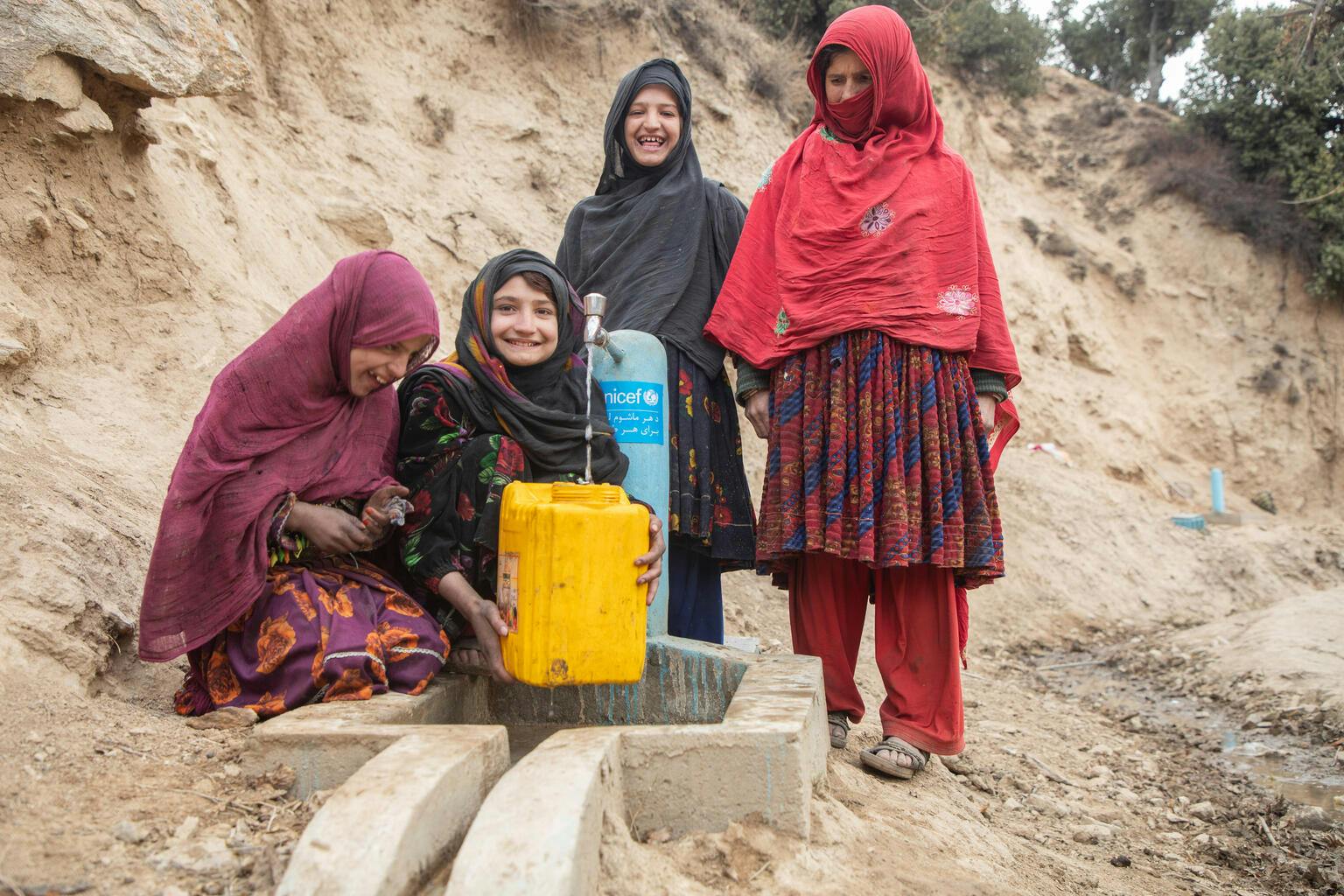 A lifetime of water - Children fill a jerry can from a new water tap in Payok Abad Village in Nuristan province's Kantiwa Valley in Afghanistan