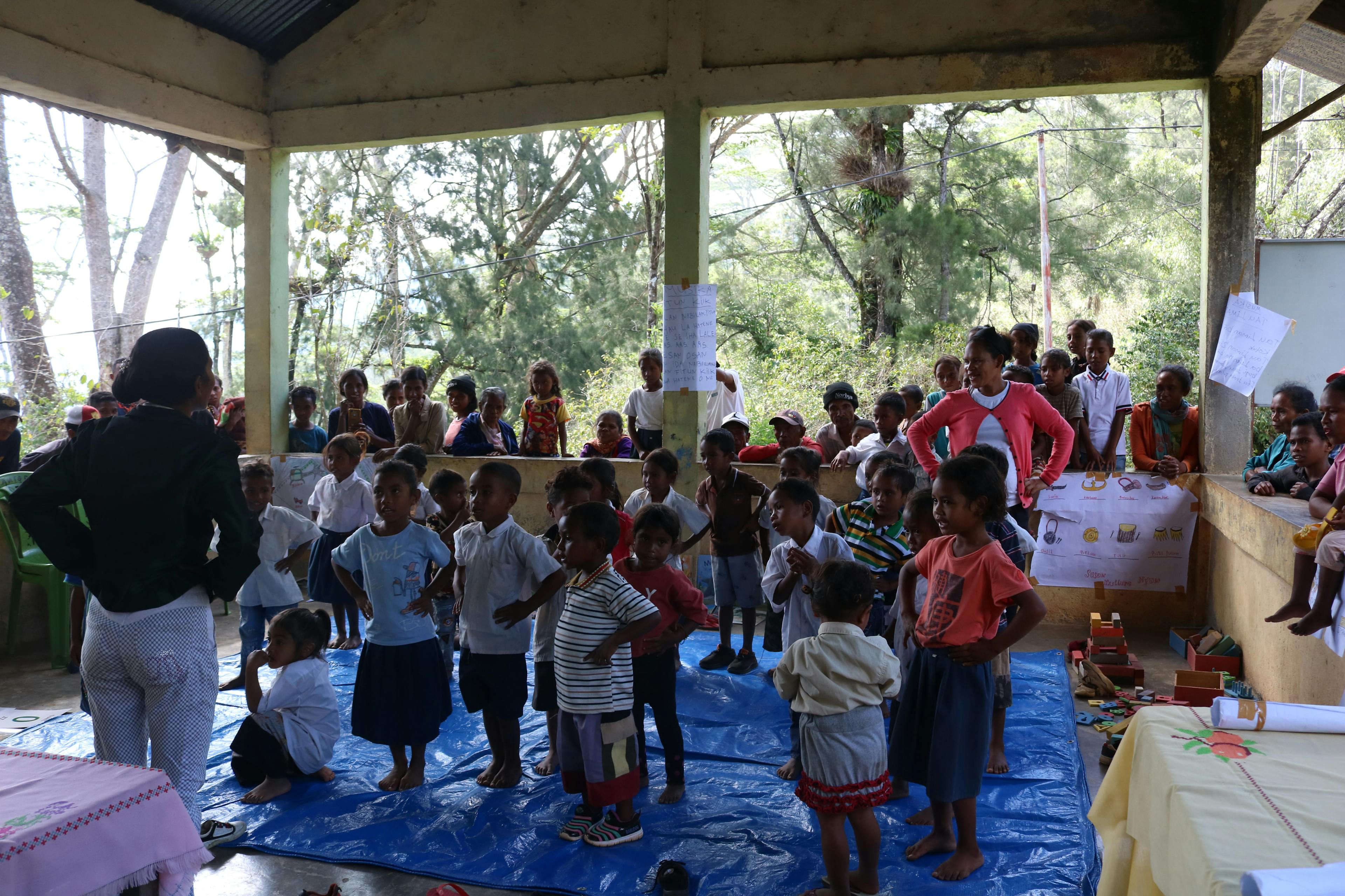 Students of Kairia preschool learning a song and dance during class. Families and community members also gathered around the classroom for our arrival.