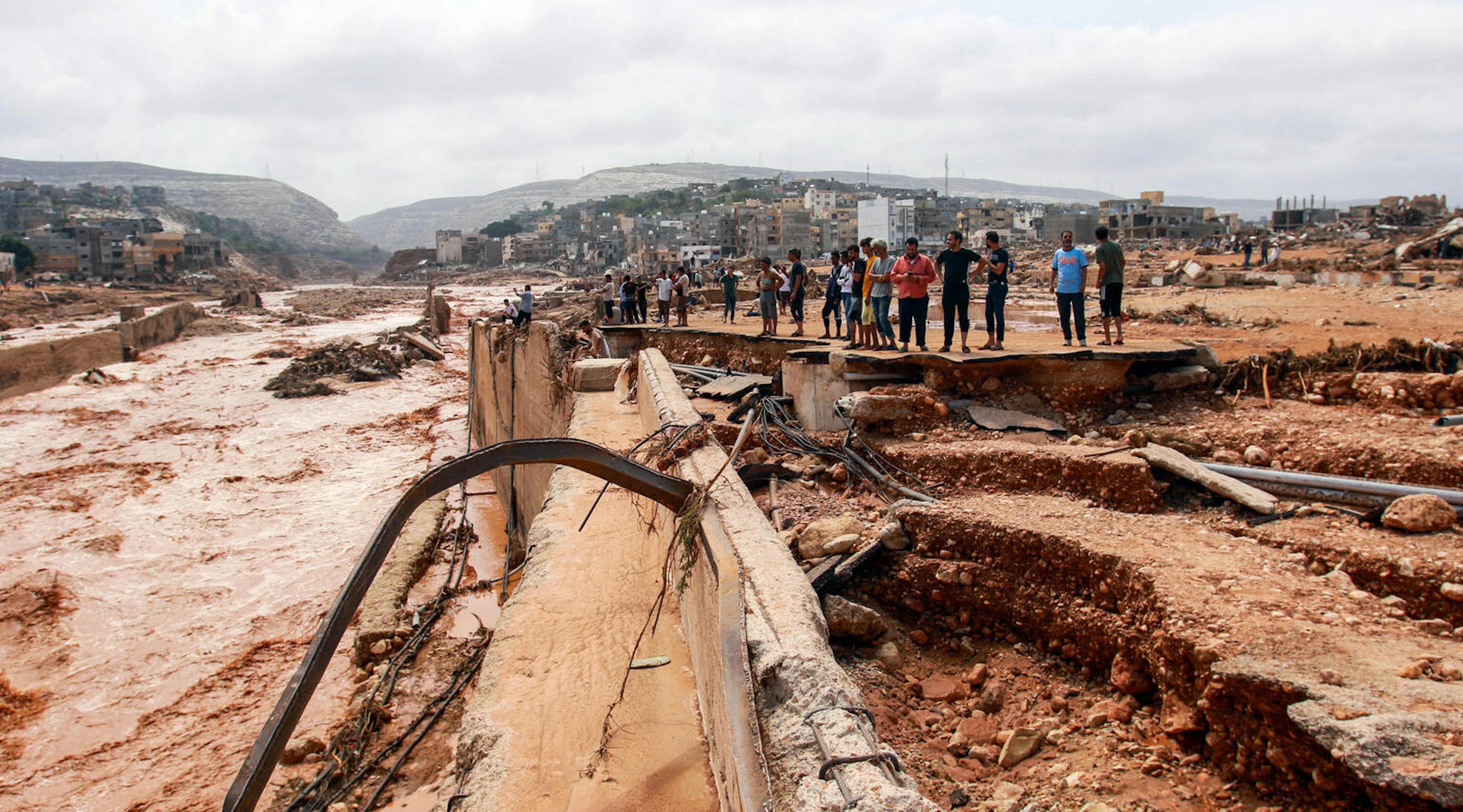 People look at the damage caused by floods in Derna, eastern Libya, on September 11, 2023. Flash floods have killed more than 2,300 people in the Mediterranean coastal city of Derna alone.