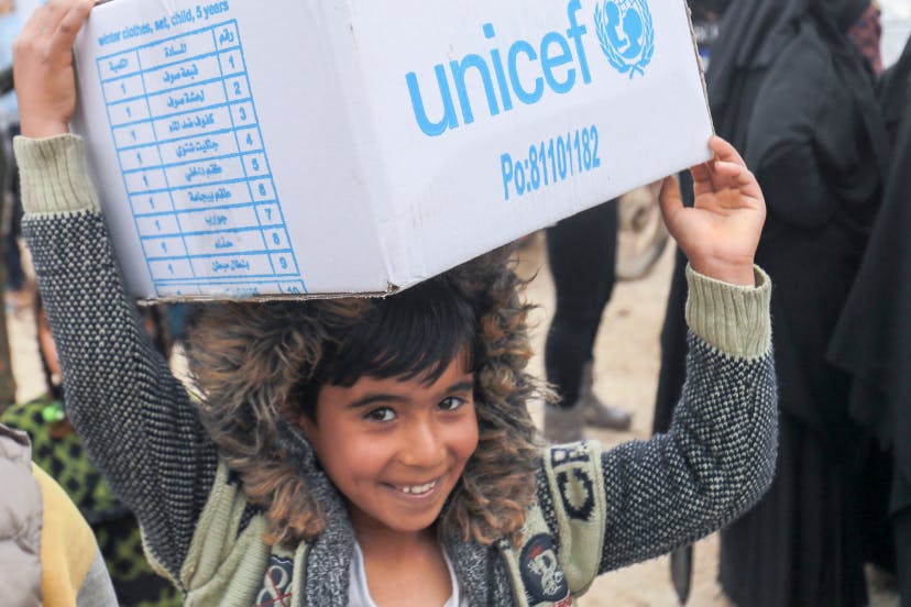 Boy carrying a UNICEF box on his head