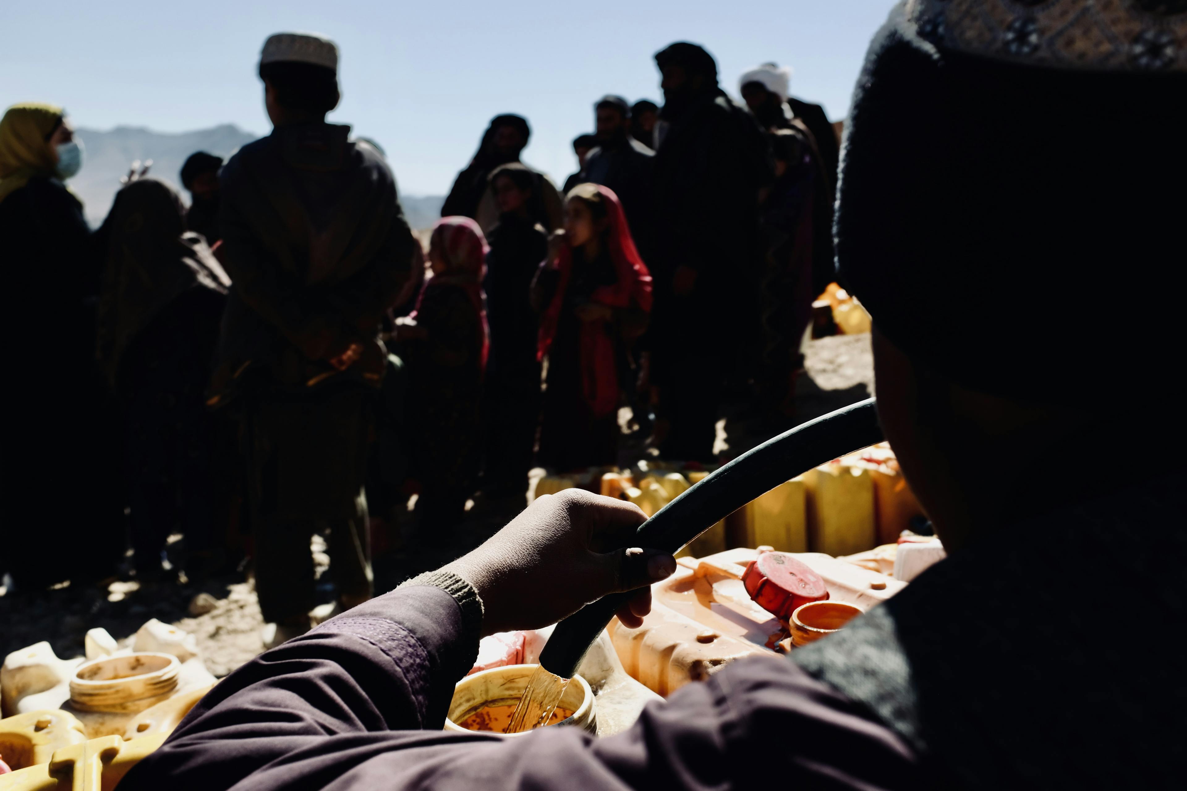 A man fills jerry cans with clean water from a UNICEF water truck in the centre of Chora District.