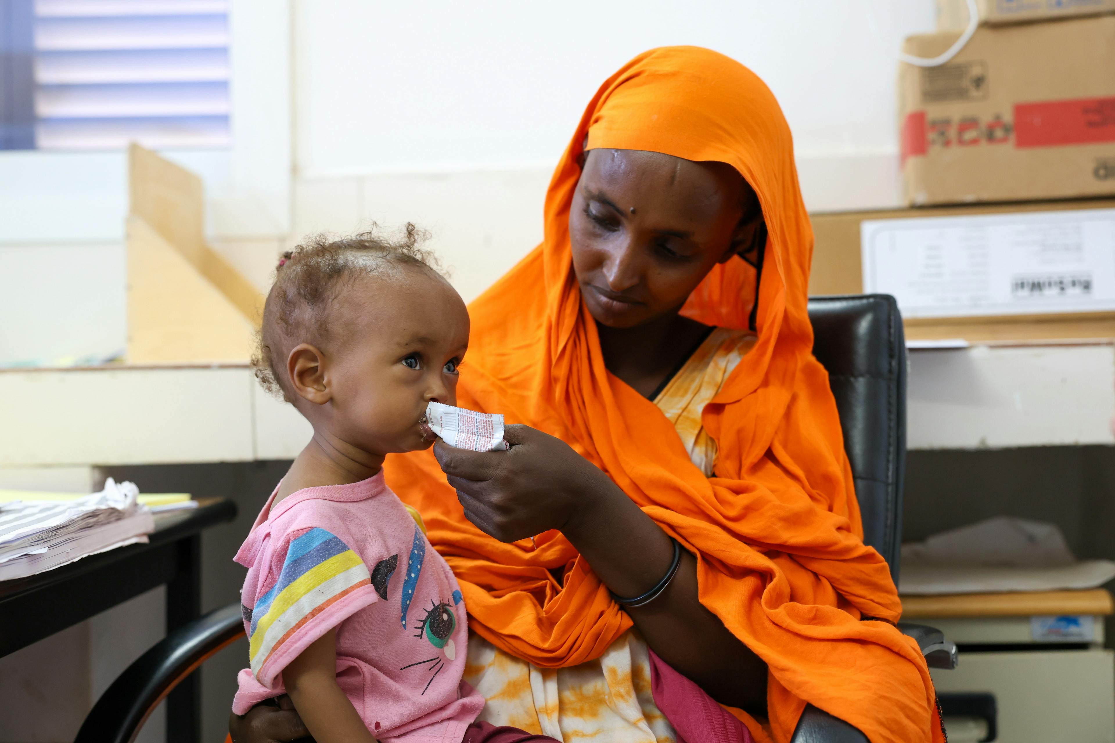 Health center in Balbala where a little girl is being fed a RUTF sachet