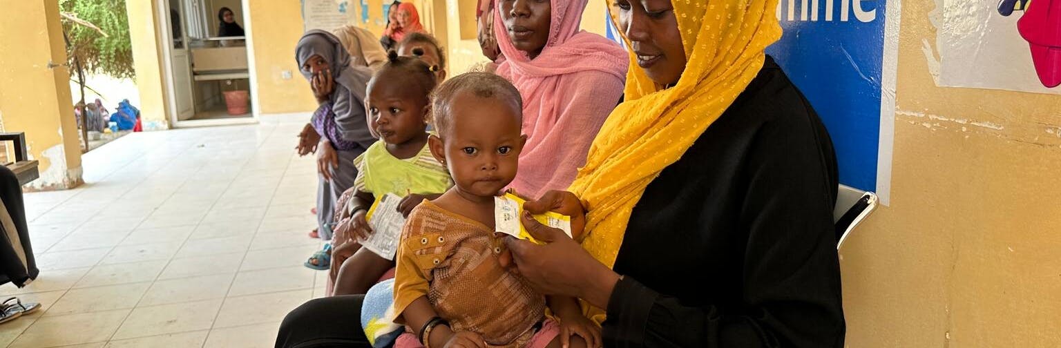 Mothers feed their children with ready-to-use therapeutic food.