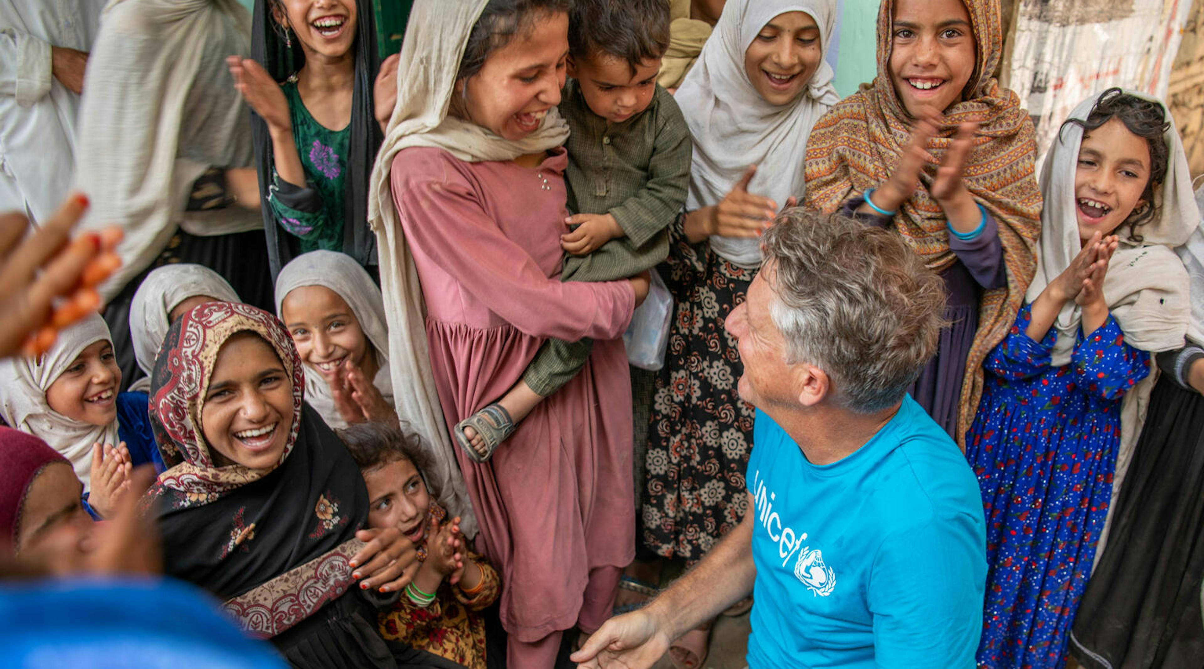Afghanistan Emergency, James Elder, UNICEF Spokesperson, plays with children at UNICEF-supported mobile health and nutrition site in Samsagal, Afghanistan.