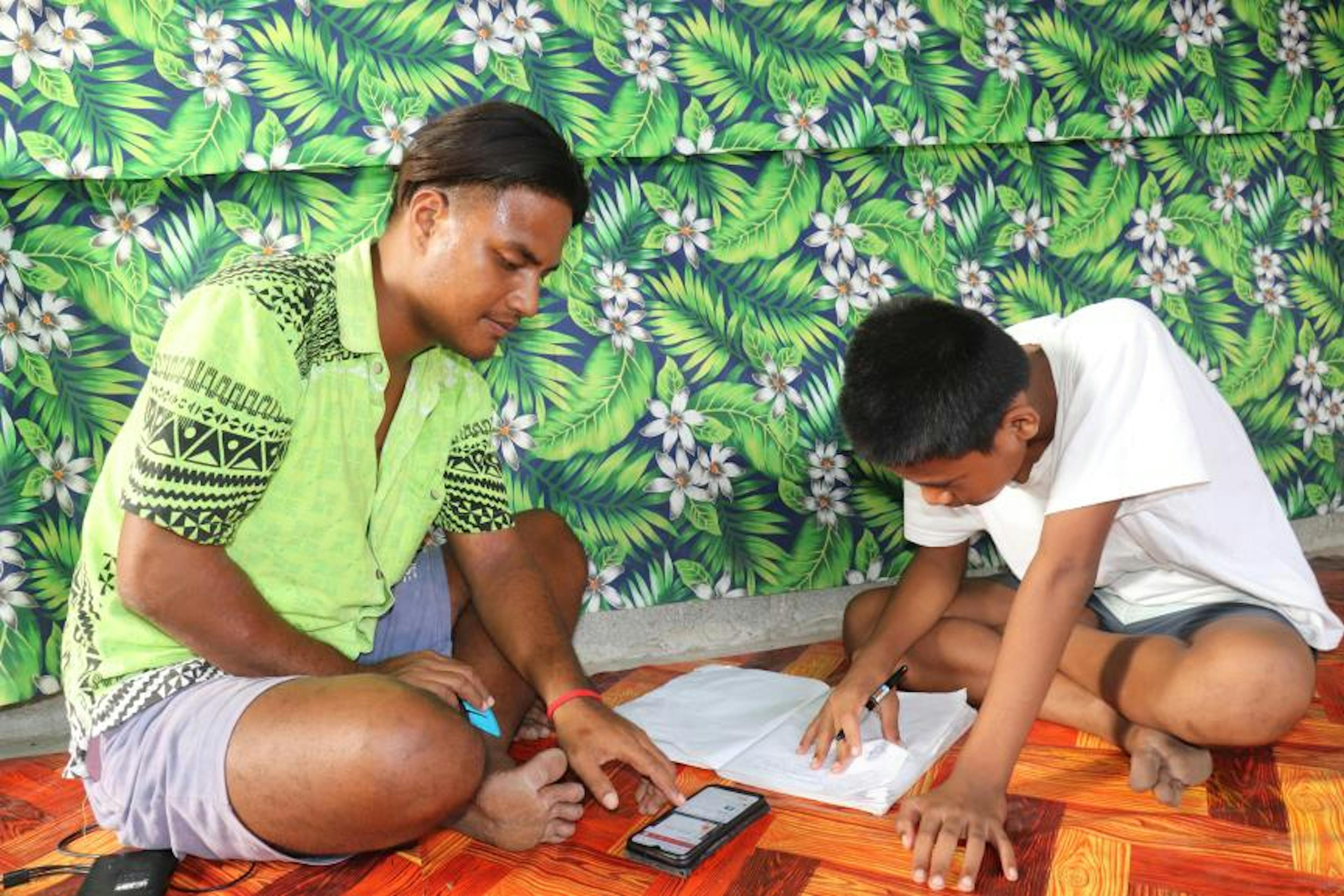 Betangnga’s uncle helps him with math problems about the perimeter of compound shapes in Learning Passport lessons.