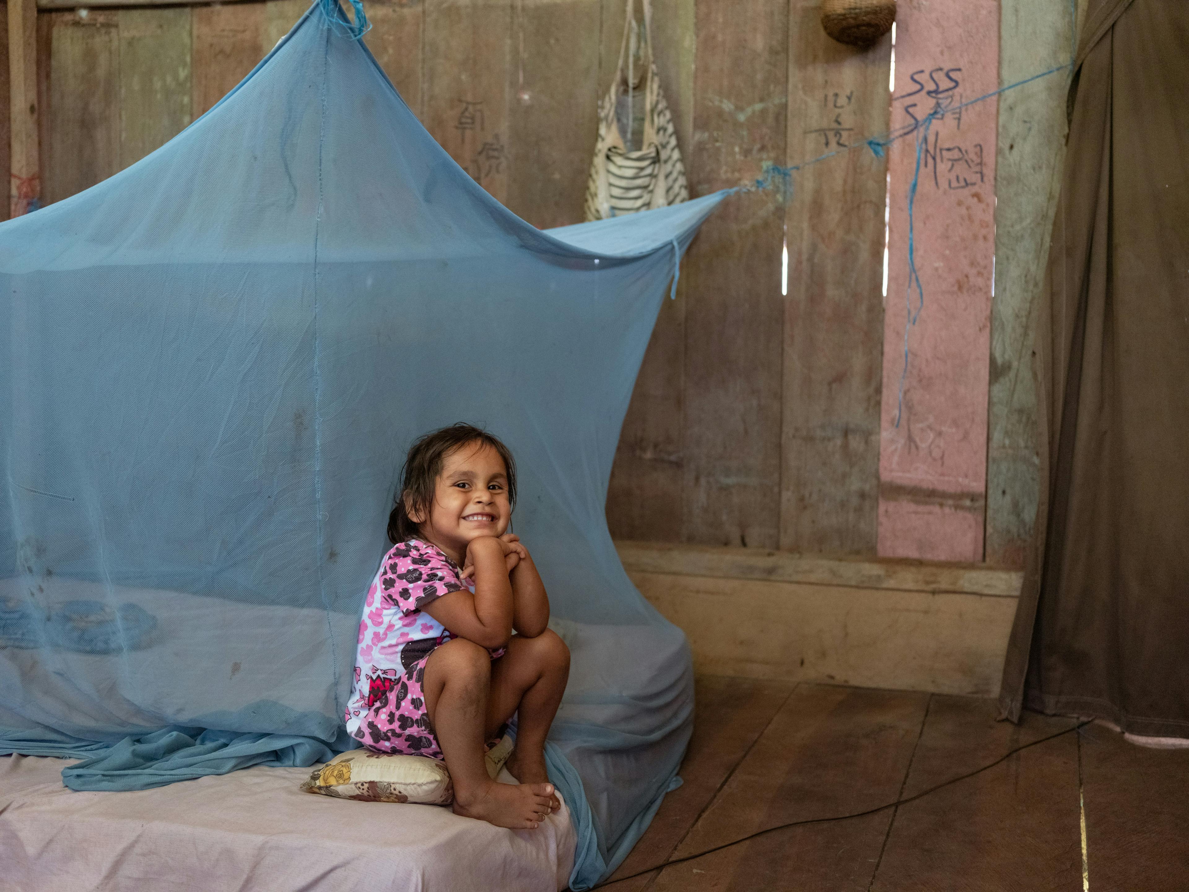 Global Parent- 3-year-old Fresia Manrique sits in her room after having been vaccinated against influenza by Nurse Maribel Vilela Grandez from a UNICEF-supported health brigade.