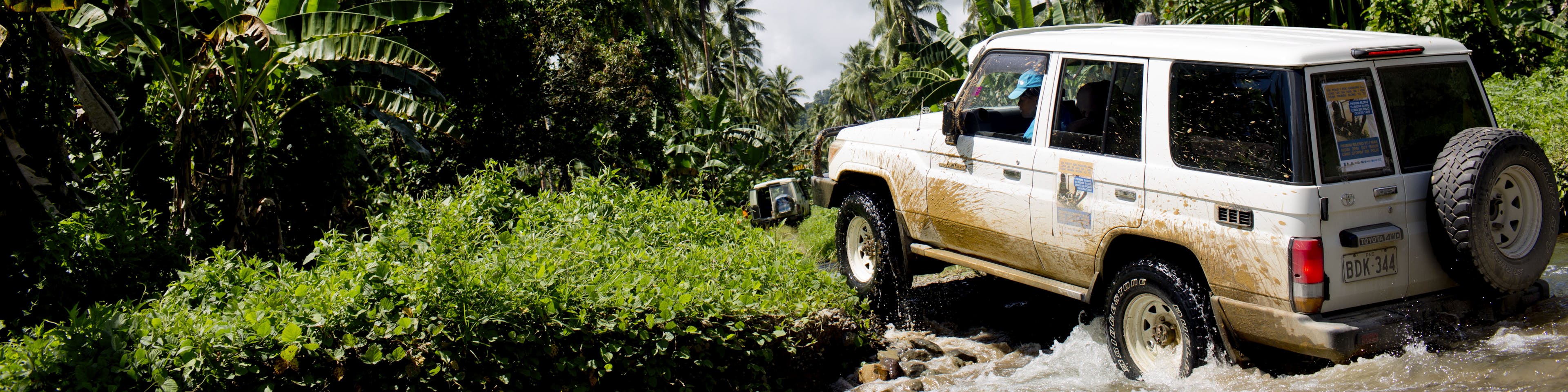 A UNICEF truck crossing a river.