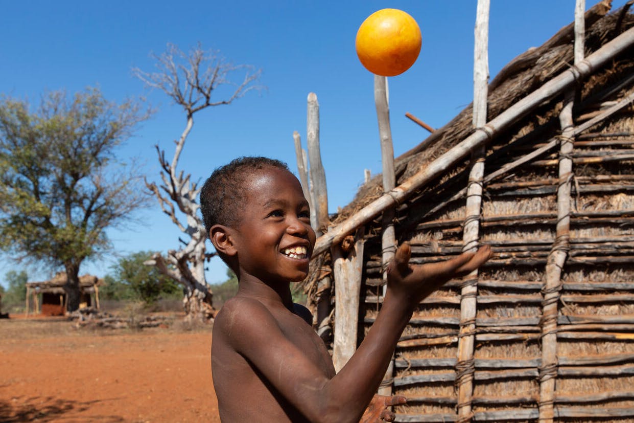 A young boy plays with a plastic ball in the village of Ampotaka, Madagascar. 
